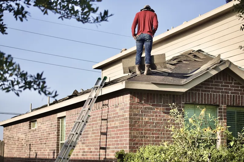Professional roofer working on a residential roof in River View Park